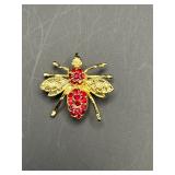 bee brooch featuring a gold-toned body