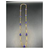 Vintage gold tone necklace with blue color beads.