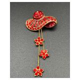 Red hat brooch pin.