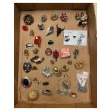 Single earrings and pins.