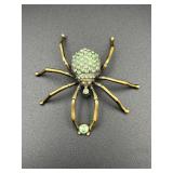 Spider brooch pin. Green rhinestones.