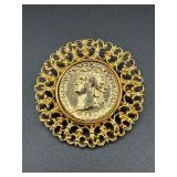 Gold tone coin style brooch pin.