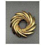 Large gold tone brooch pin.