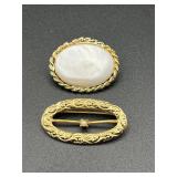 Two brooches pins.