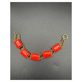 Vintage bracelet with red rectangular accents.