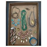 Jewelry tray. Assortment of jewelry pieces.