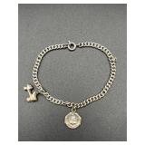 Vintage bracelet marked 925. Two charms.
