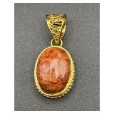 Gold tone Pendant, marked Karis.