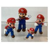 4 Super Mario Brothers action figures, tallest is