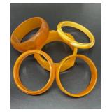 5 Thick plastic orange bracelets.