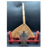 Vintage cast iron trivet, with a broom stick
