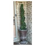 Artificial boxwood spiral topiary tree in dark