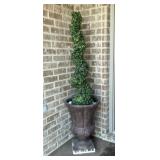 Artificial boxwood spiral topiary tree in dark