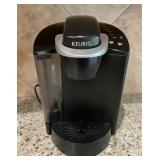Keurig Black and silver coffee maker. Powers on