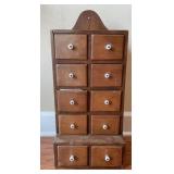 Vintage wooden apothecary-style storage cabinet.