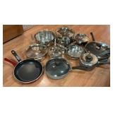 12 assorted pans and skillets with lids.