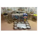 24 assorted mason jars and glass canning jars