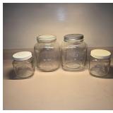 Four Clear Glass Storage Jars