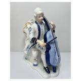 vintage porcelain figurine depicting a musician