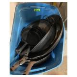 large totes of woks and skillets