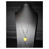 Orange enameled heart on a rope