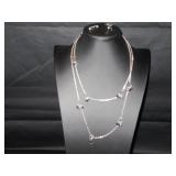 Long silver tone chain with black beads...