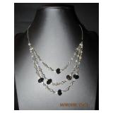 Silver tone triple strand clear & black beads