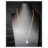 Gold tone necklace with a heart hanging