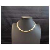 Gold tone choker with dangling squares and circles