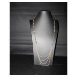 Long silver tone necklace with leather woven...