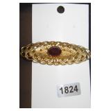 Gold-Tone Filigree Brooch with Red Rhinestone