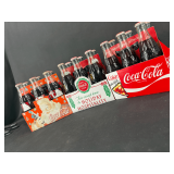 Collection of Coca-Cola Commemorative Glass Bottles in Carriers