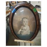 Oval Bubble Glass Framed Baby with Tongue out