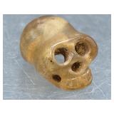 Carved stone skull amulet