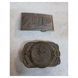 7UP and trappers' association belt buckles. B-70