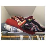 Blankets and quilts in top of closet. D428