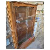 Wood and glass gun case. D587