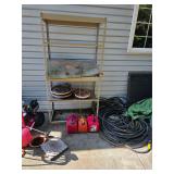 Gas cans, garden hose, metal shelving. D635
