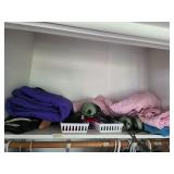 Contents in top of closet, snow pants, more. D379