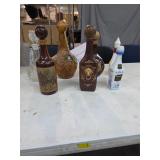 Various vintage leather wrapped decanters. 21-11