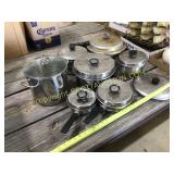 Seven cooking pots and pans with lids, pressure