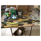 Green tote, full of lawn and garden tools and
