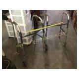 Two aluminum folding handicap walkers
