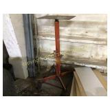 Red hydraulic highboy transmission jack on