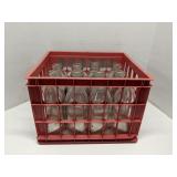 Plastic crate of old glass milk bottles