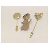 Group of gold tone stick pins & brooch