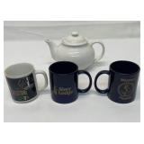Coffee mugs with a ceramic teapot.
