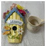 Wall decoration with a small creamer pitcher.