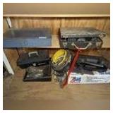 CONTENTS OF BOTTOM SHELF AND AREA BELOW INCLUDING METAL BOXES, LARGE DEWALT HAMMER DRILL, WIRING, COAXIAL CABLE, BLACK & DECKER CORDLESS ROTARY TOOL, TOOL BAGS IN ORIGINAL BOX, AND MORE