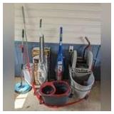 CLEANING ACCESSORIES IN AREA MARKED OFF AS 1099 INCLUDING COMMERCIAL MOP BUCKET, SPIN MOP BUCKET, HOOVER FLOOR SCRUBBER, SHARK PRO STEAM POCKET MOP WITH ORIGINAL BOX, AND MORE